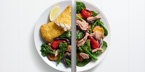 Split plate featuring crumbed hoki fillets with roast vegetables on one side, and a winter tuna salad with spinach, broccolini, and red capsicum on the other.
