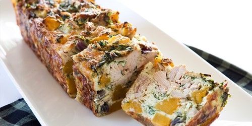 Golden-baked tuna loaf made with Sealord tuna in olive oil, layered with chunks of pumpkin, leafy greens, and herbs—sliced and ready to serve.