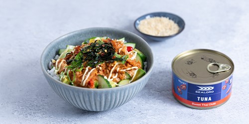 sealords sweet chilli tuna can sitting next to a poke bowl and ramekin of raw rice.
