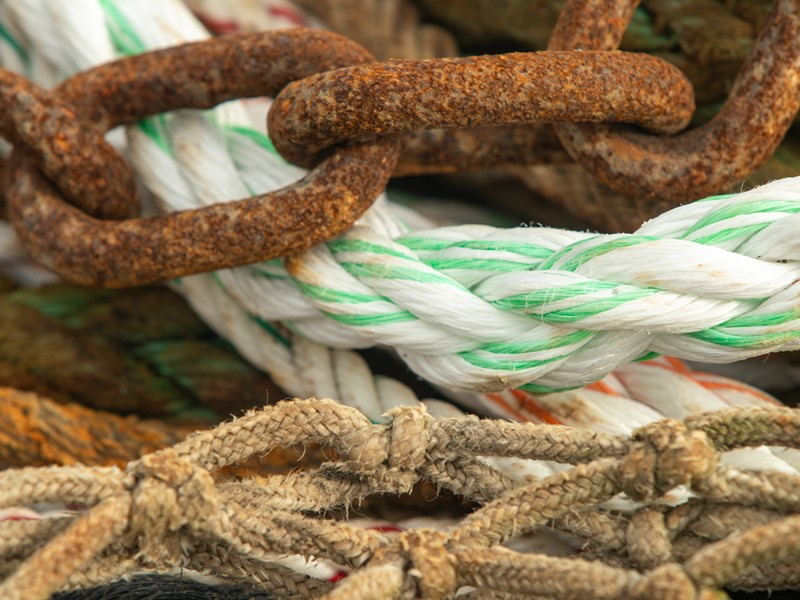 close up shot of ropes and chains intertwined together